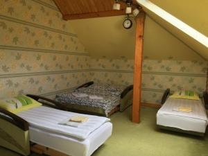 a room with two beds in a room at Mansarda Aparts in Skole