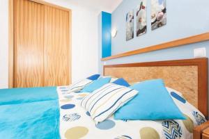 a bed room with a blue bedspread and a blue comforter at LC's Guesthouse in Lagos