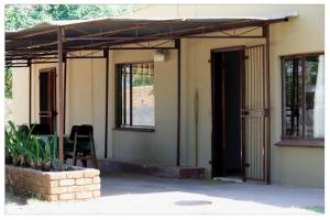 a porch of a house with an open door at Old farmhouse for 3 in Limpopo Province in Lephalale