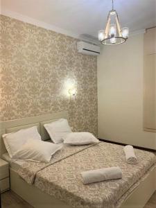 a bed with two pillows on it in a bedroom at Griboedov 13 in Tbilisi City