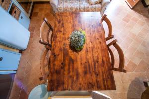 a wooden table with a plant on top of it at Podere Piazza Siena in Siena +45 photos