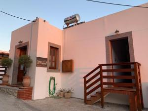 a white building with a staircase next to a door at Mistral-Patmos in Patmos
