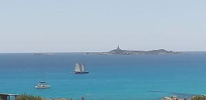 a sail boat in a large body of water at VILLA CLAUDIO e LUNETTA in Villasimius