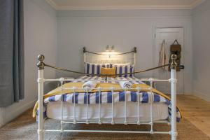a bedroom with a bed with a white frame at The Sands Sheringham in Sheringham
