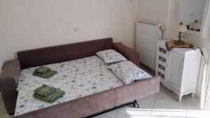 a small bedroom with a bed and a dresser at Classic-style apartment in Loutra Edipsou