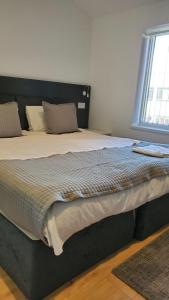 a large bed in a bedroom with a window at Bell Gate House in Leicester