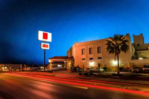 a city street at night with a gas station at Fiesta Inn Monclova in Monclova