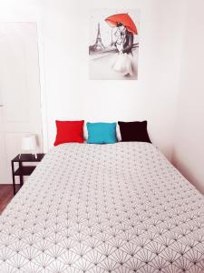 a bedroom with a large bed with an umbrella at Studio dans un quartier résidentiel à Montrouge avec le métro à 2 min in Montrouge