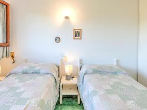 A bed or beds in a room at Holiday Home in Punta Ala by the Sea