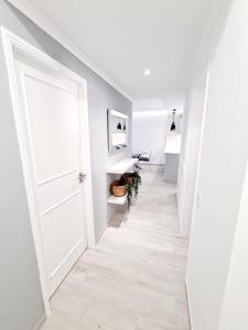 a hallway with a white door and a white floor at Central and New Fancy 2 Bedroom Apart.w/ 2 Wc in Faro
