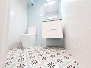 a bathroom with a toilet and a tiled floor at Central and New Fancy 2 Bedroom Apart.w/ 2 Wc in Faro