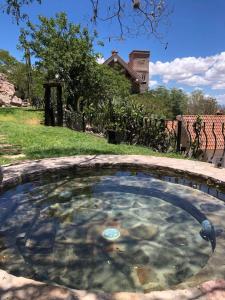 a small pool of water in a yard at Hotel de Piedra in Bernal