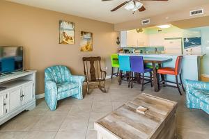 ein Wohnzimmer mit einer Küche sowie einem Tisch und Stühlen in der Unterkunft Pelican Isle Condominiums in Fort Walton Beach