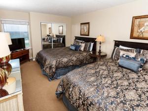 a hotel room with two beds and a television at Island Echos 6th Floor Condos in Fort Walton Beach