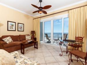 a living room with a couch and a view of the ocean at Windemere Condominiums in Perdido Key