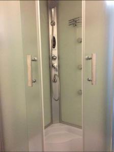 um chuveiro na casa de banho com um espelho em Сдам ПОСУТОЧНО уютную квартиру на Марсельской em Kryzhanivka