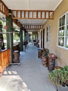 an empty hallway of a building with plants at Hemingway Cottage 海明威度假屋 in Semporna