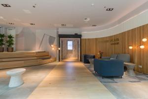 a lobby with a waiting area with chairs and a door at Crowne Plaza Utrecht - Central Station, an IHG Hotel in Utrecht