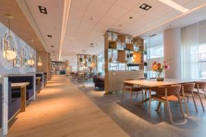 烏特勒支的住宿－Crowne Plaza Utrecht - Central Station, an IHG Hotel，大楼内带桌椅的用餐室