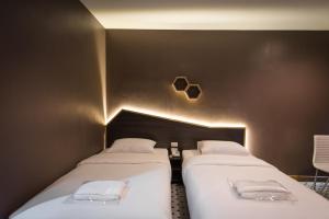 A bed or beds in a room at The Feeling Hotel