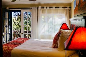 a bedroom with a bed and a lamp at Lantern Light Inn - Romantic Getaway in Sedona