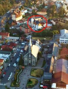 a building with a red circle on it in a city at Centro de gramado in Gramado