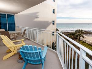 a balcony with chairs and a table and the beach at Waterscape B III in Fort Walton Beach