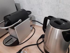 a tea pot and a tea kettle on a table at Appartement AAD1 Clamart 200 m du Tramway T6 st pavé blc avec cuisine séparée in Clamart