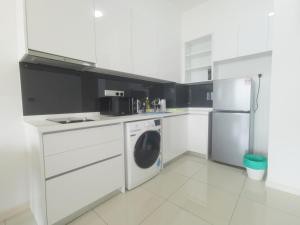 a white kitchen with a stove and a refrigerator at The Elysia Park Residence by Home Owner in Johor Bahru