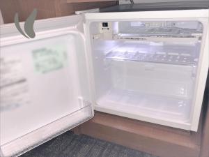 an empty refrigerator with its door open in a kitchen at Hotel Hokke Club Kumamoto in Kumamoto