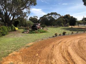 an old truck sitting in a field next to a dirt road at Nutcrackers Lodge in Esperance +21 photos