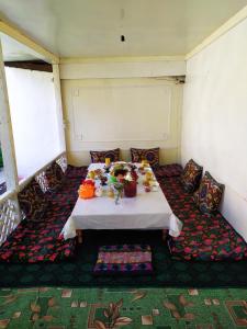 a room with a table with food on it at Riverside Guest house Mashkhur in Arslanbob
