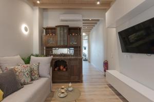 a living room with a couch and a fireplace at V77 Seafront Suites in Rethymno