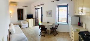 a kitchen and living room with a table and chairs at Villa Amalia in Halki