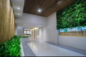 a hallway with a green wall in a building at Hi Season Hotel in Hat Yai