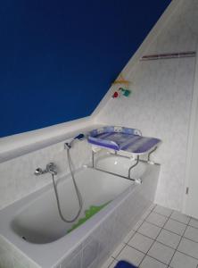 y baño con bañera con cabezal de ducha. en Haus Löwenzahn en Hüttenrode