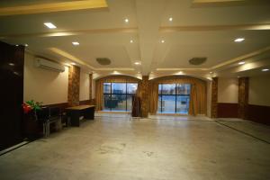 a large room with a lobby with glass doors at Click Hotel Capital House in Patna