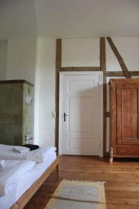 a bedroom with a bed and a white door at Gutshaus Thorstorf FeWo Groß Schwansee in Warnow