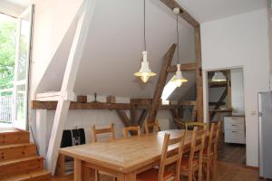 a dining room with a wooden table and chairs at Gutshaus Thorstorf FeWo Groß Schwansee in Warnow