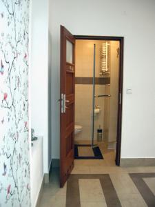 a bathroom with a toilet and a glass door at Trend Apartment Old Market Rzeszów in Rzeszów