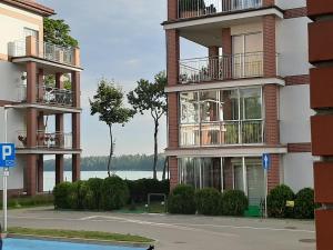 a building with balconies on the side of a street at Apartament nad Jeziorem Olecko in Olecko