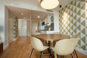 a kitchen and dining room with a table and chairs at ELEVEN Apartments Real de la Carretería, by Homing U in Seville +128 photos