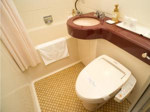 a bathroom with a toilet and a sink at Smile Hotel Sasebo in Sasebo +21 photos