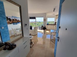 a mirror in a living room with a table and chairs at Apartment Marinela in Krk +13 photos
