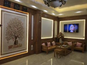 a living room with a tree on the wall at Hưng Thành Riverside Hotel in Thái Bình