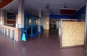 a hallway of a building with blue walls and a door at HOTEL LAGO in Villanueva de Arosa