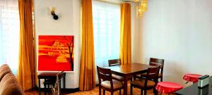 a dining room with a table and chairs at Silent Sky Homestay near JKIA Airport & SGR Nairobi in Nairobi +8 photos