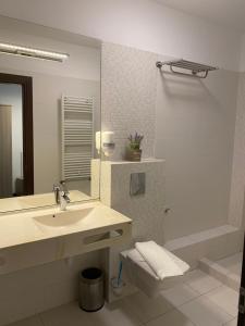 a bathroom with a sink and a toilet and a mirror at Parliament Square in Bucharest