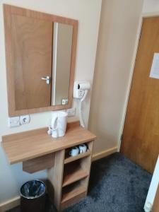 a bathroom with a sink and a mirror at Colliers Hotel in London