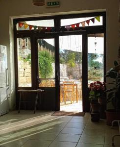 an open door to a patio with a table outside at B & B Monte Adamo in Conversano